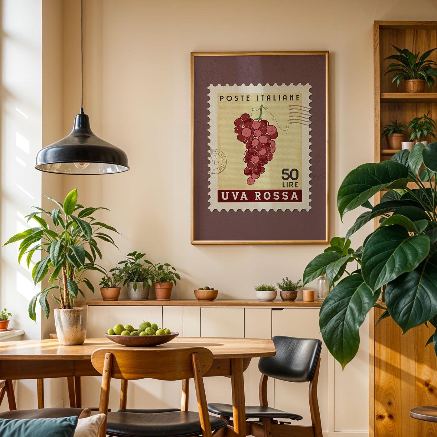a cozy dining area with a wooden table, chairs, and potted plants. A framed stamp with a grape vine and the text "POSTE ITALIERE 50 LIME UVA ROSSA" hangs on the wall above the table.