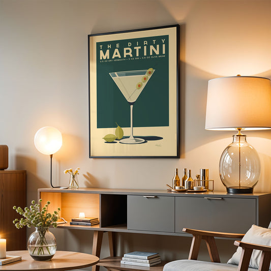 a living room with a framed poster of a martini glass hanging on the wall, a wooden sideboard with various items on it, and a lamp on a table.
