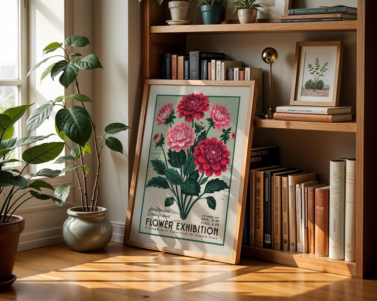 a picture of flowers on a shelf next to a potted plant