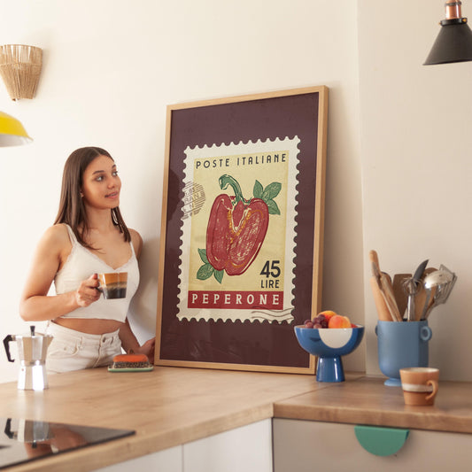 a woman standing in a kitchen next to a framed poster