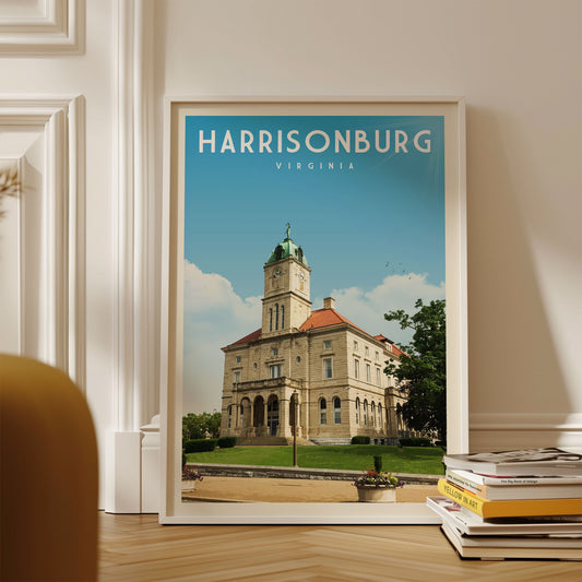 A framed poster of the historic Harrisonburg, Virginia, with a large building and a green dome visible against a blue sky.