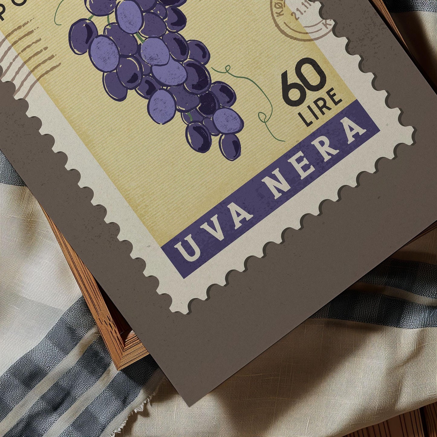 A close-up of a postage stamp featuring a bunch of purple grapes, with the text "60 LIR" and "UVA NERA" printed on it.