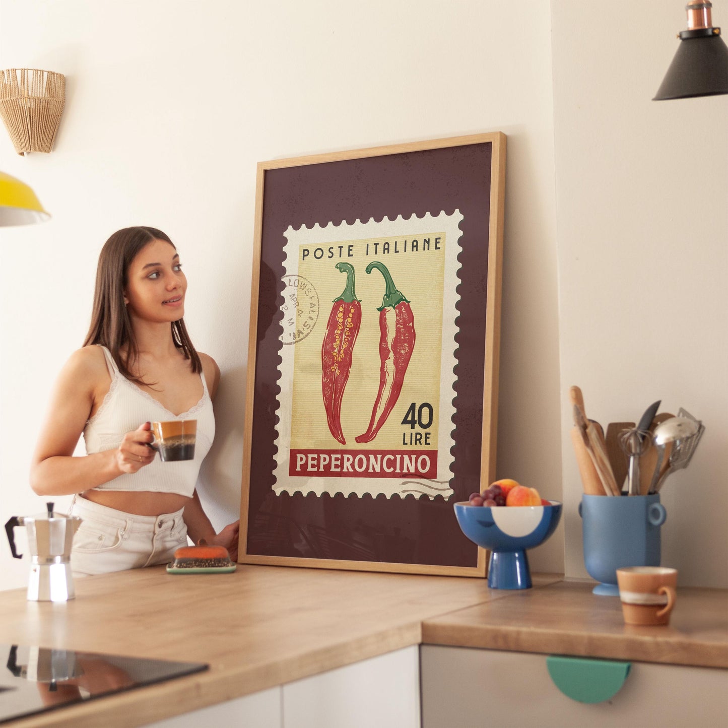 a woman standing in a kitchen next to a poster
