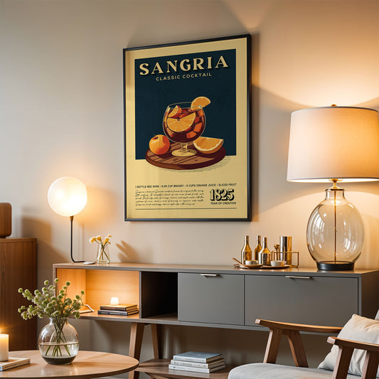 a framed poster of a classic cocktail called "Sangria" hanging on a wall in a living room. The poster displays an illustration of a glass filled with a red liquid, likely a cocktail, and various fruits such as oranges and apples. The poster also includes text that describes the ingredients and preparation of the cocktail.