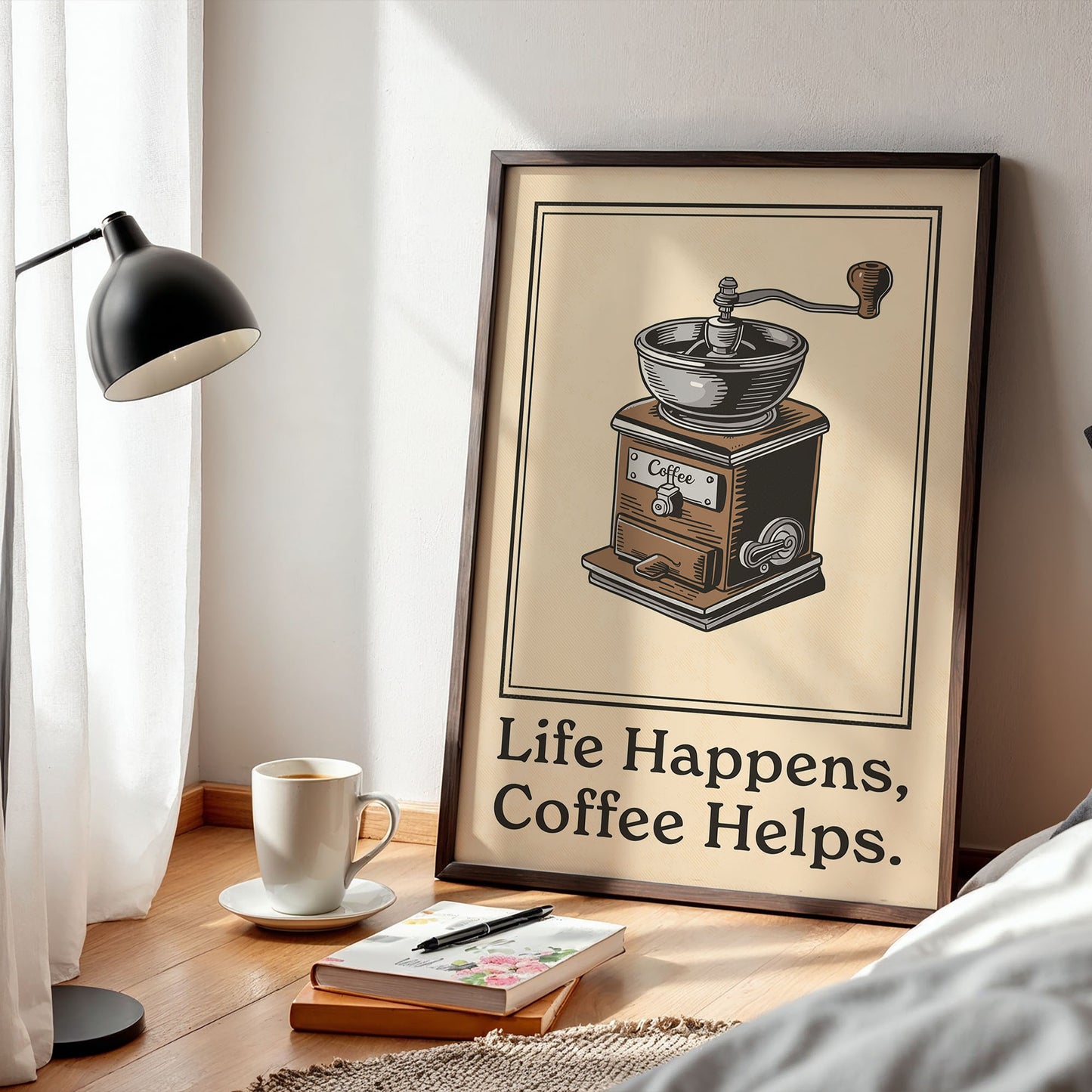 a framed poster with an illustration of a coffee grinder, accompanied by the text "Life Happens, Coffee Helps." The poster is placed on a wooden floor next to a lamp and a cup of coffee.