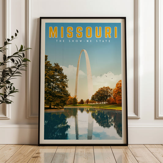 A framed poster of the Gateway Arch in Missouri, with a serene landscape featuring the arch reflected in a body of water.