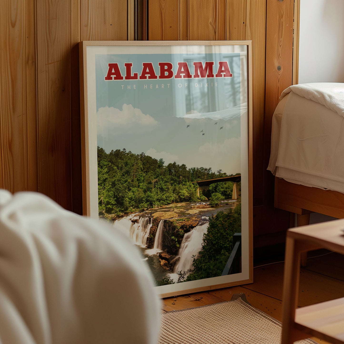 A framed poster of a waterfall in Alabama, with the text "ALABAMA THE HEART OF DIXIE" prominently displayed.
