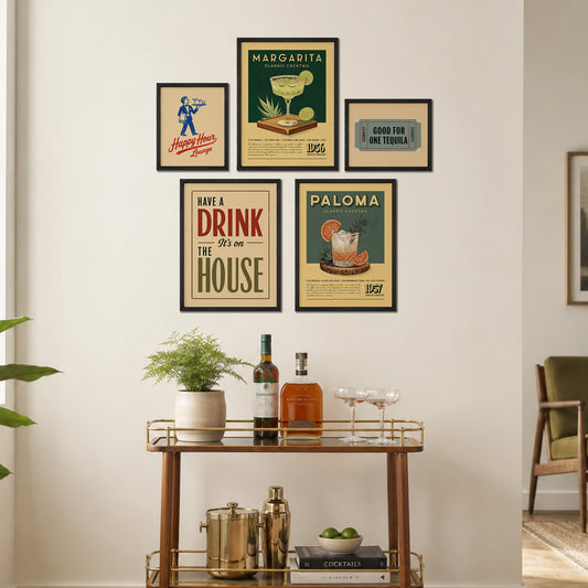 a wall display with framed vintage-style posters and a wooden bar cart with various cocktail ingredients and glassware.