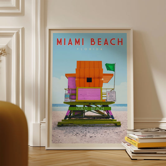 A framed poster of a lifeguard tower on the beach, with the text "MIAMI BEACH FLORIDA" prominently displayed.