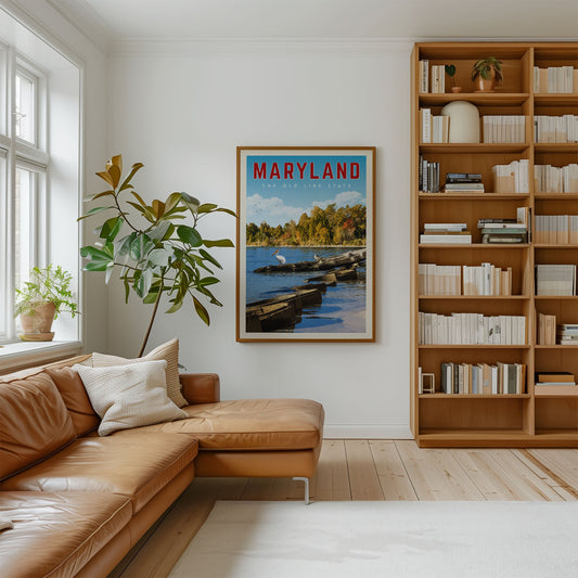 a cozy living room with a large bookshelf filled with books, a comfortable leather couch, and a framed poster of a scenic view of the Chesapeake Bay.