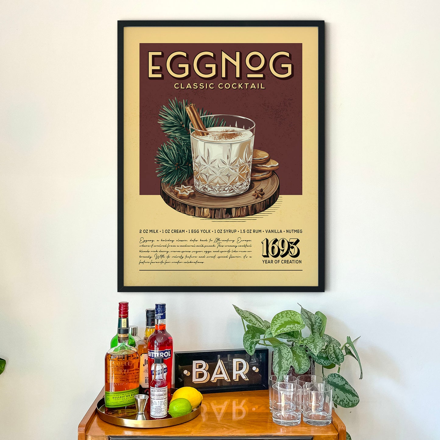 a framed advertisement for a classic cocktail called Eggnog, which is a creamy, egg-based drink served in a glass with a cinnamon stick. The advertisement displays the drink in a glass and includes text describing the ingredients and the cocktail's preparation. The image also includes a bar setting with various bottles of alcohol and glasses, suggesting a festive or celebratory atmosphere.