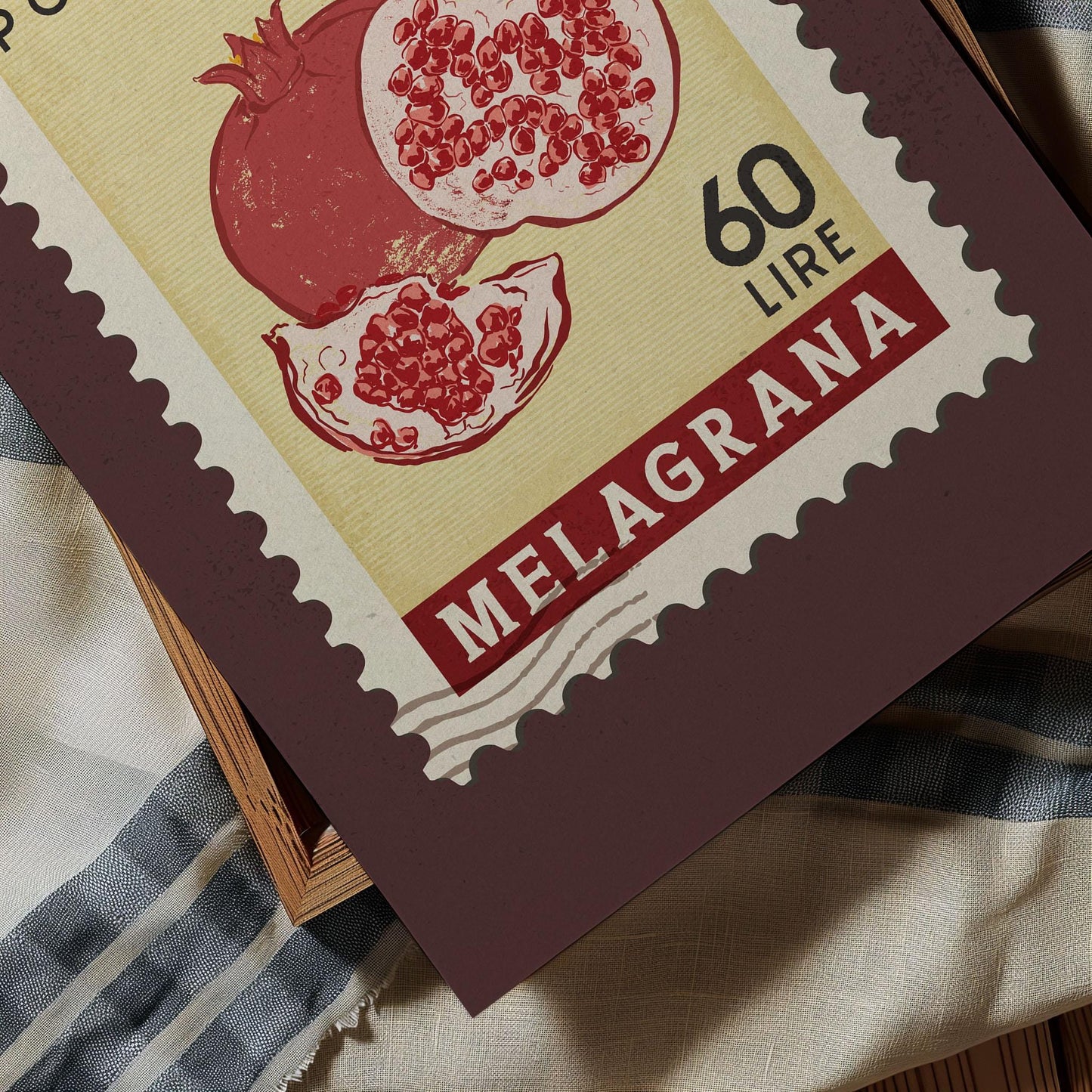 A close-up of a postage stamp featuring an illustration of pomegranates, with the text "60 LIRNE" printed on it.