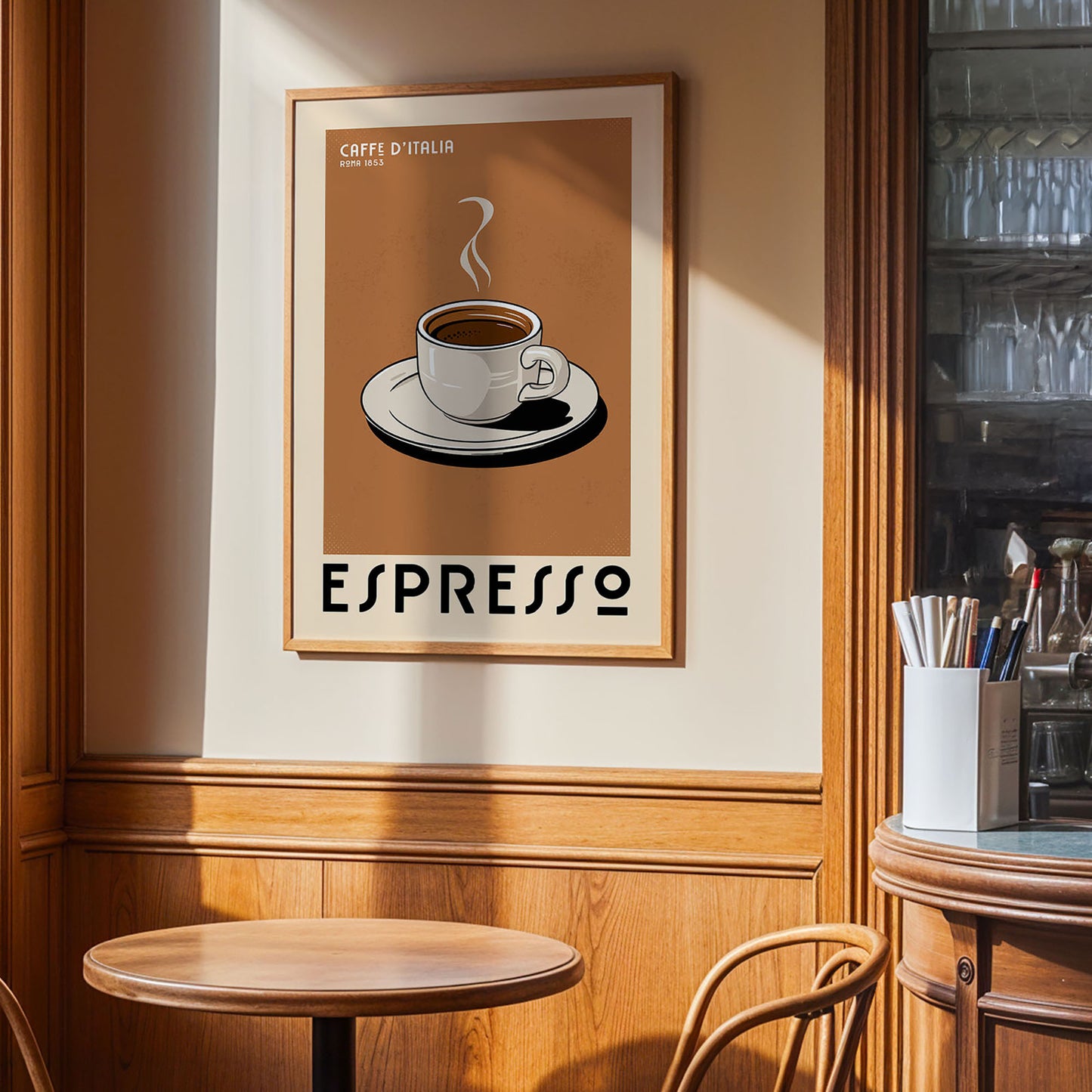 a framed poster of a cup of espresso on a wall, with a wooden table and chairs in the foreground.