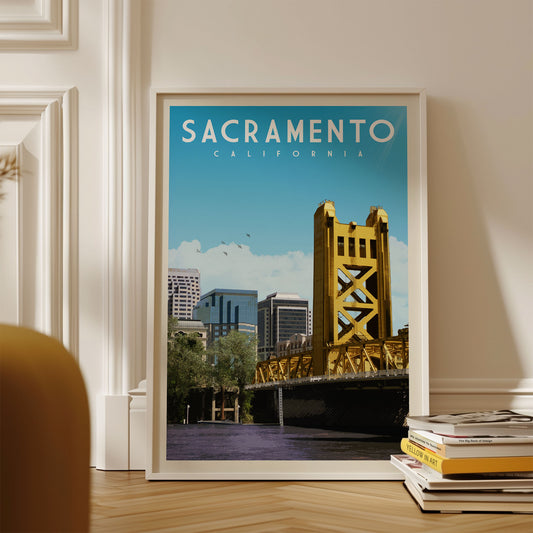 A framed poster of the Golden Gate Bridge in Sacramento, California, with a cityscape in the background.