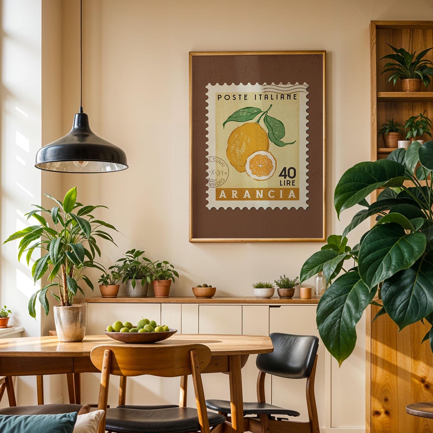 a cozy dining area with a wooden table, chairs, and a potted plant. A framed stamp with an orange and green illustration hangs on the wall above the table.