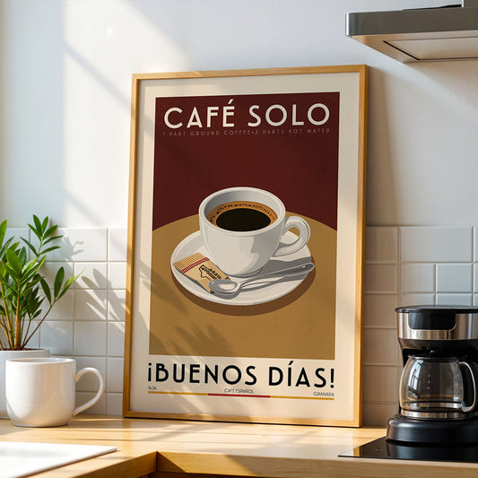 a framed poster of a cup of coffee on a table, with the text "Café Solo" and "iBUENOS DÍAS!" displayed prominently.