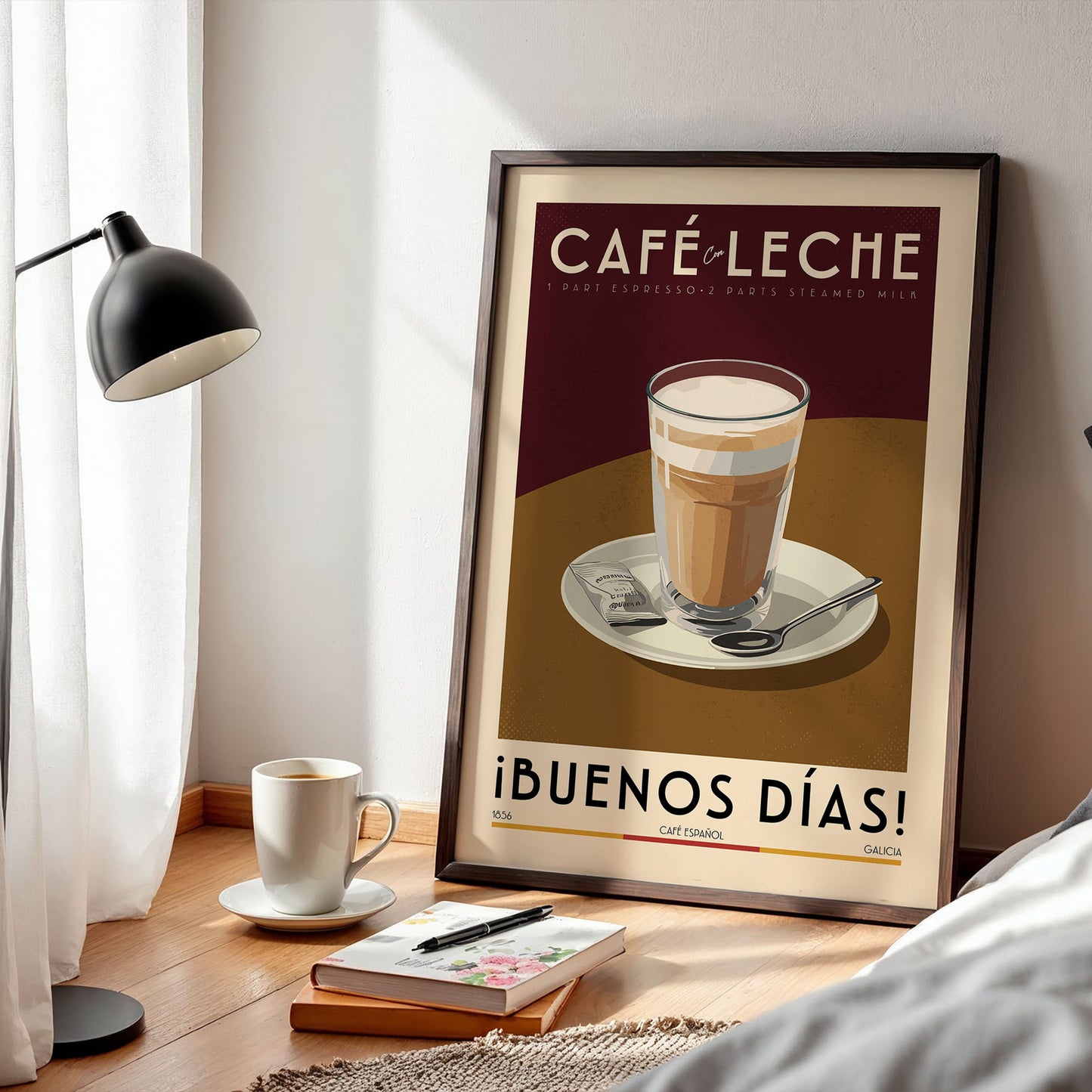 a framed poster of a coffee cup on a table, with a lamp, a book, and a cup of coffee nearby.