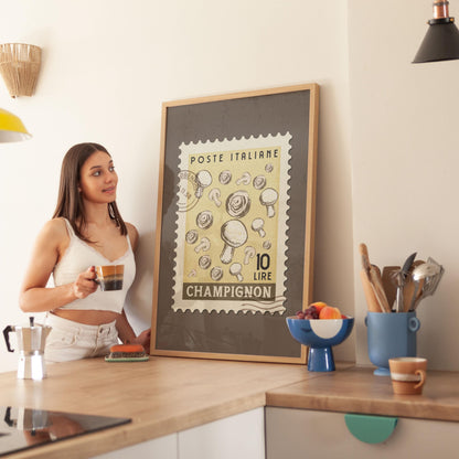 a woman standing in a kitchen next to a framed poster