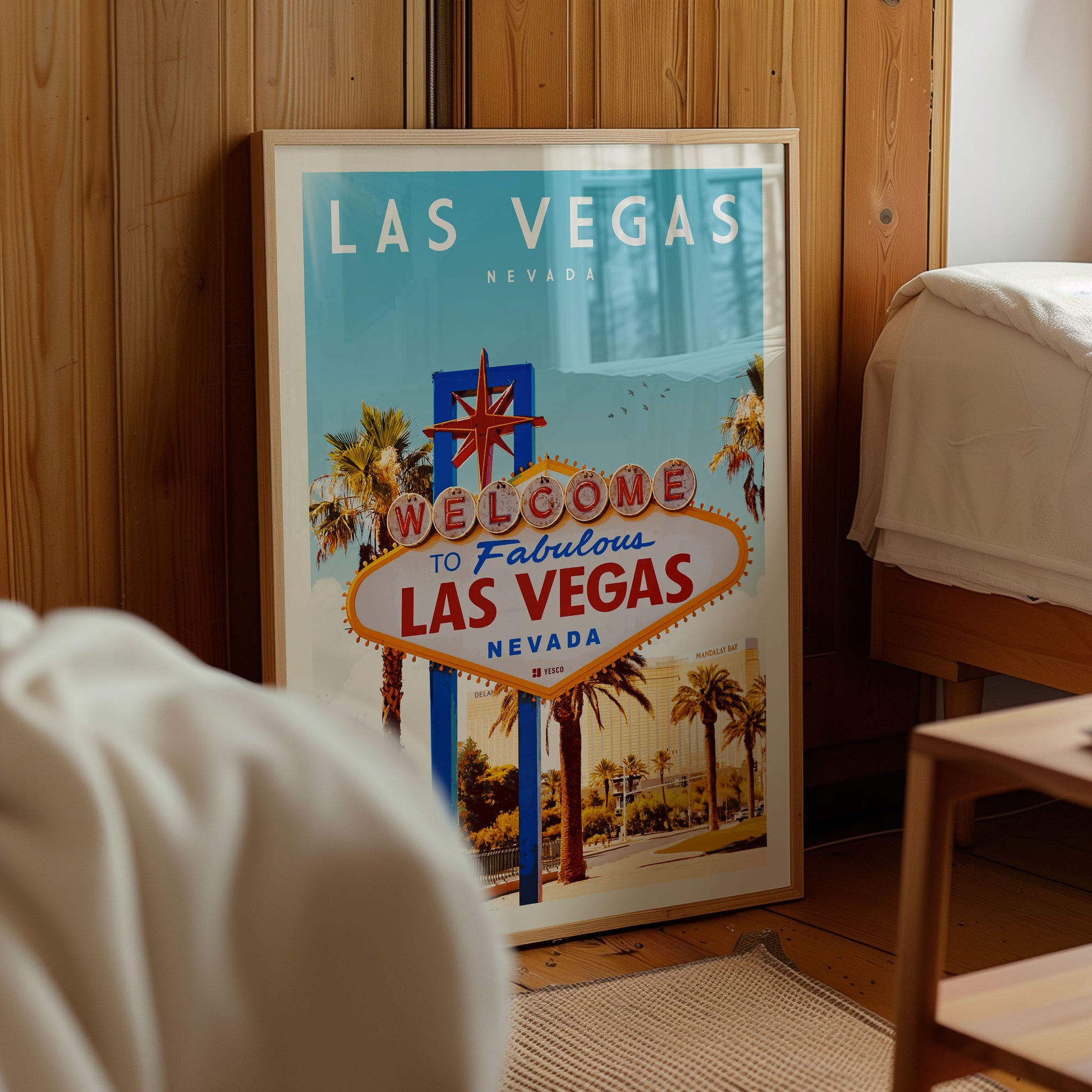 A framed poster of the Las Vegas sign, which is a famous landmark in Nevada, is displayed in a room.