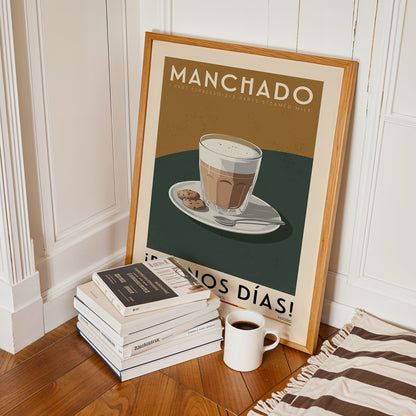 a framed poster of a cup of coffee with cookies, placed on a wooden floor next to a stack of books and a white mug.