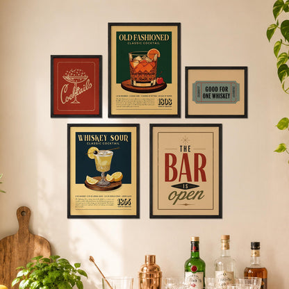 a wall adorned with framed vintage cocktails and a sign that reads "The bar is open", suggesting a bar or restaurant setting.