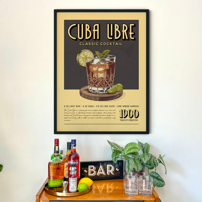 a framed poster of a classic Cuban cocktail recipe, hanging on a wall above a wooden bar counter with various liquor bottles and glasses.