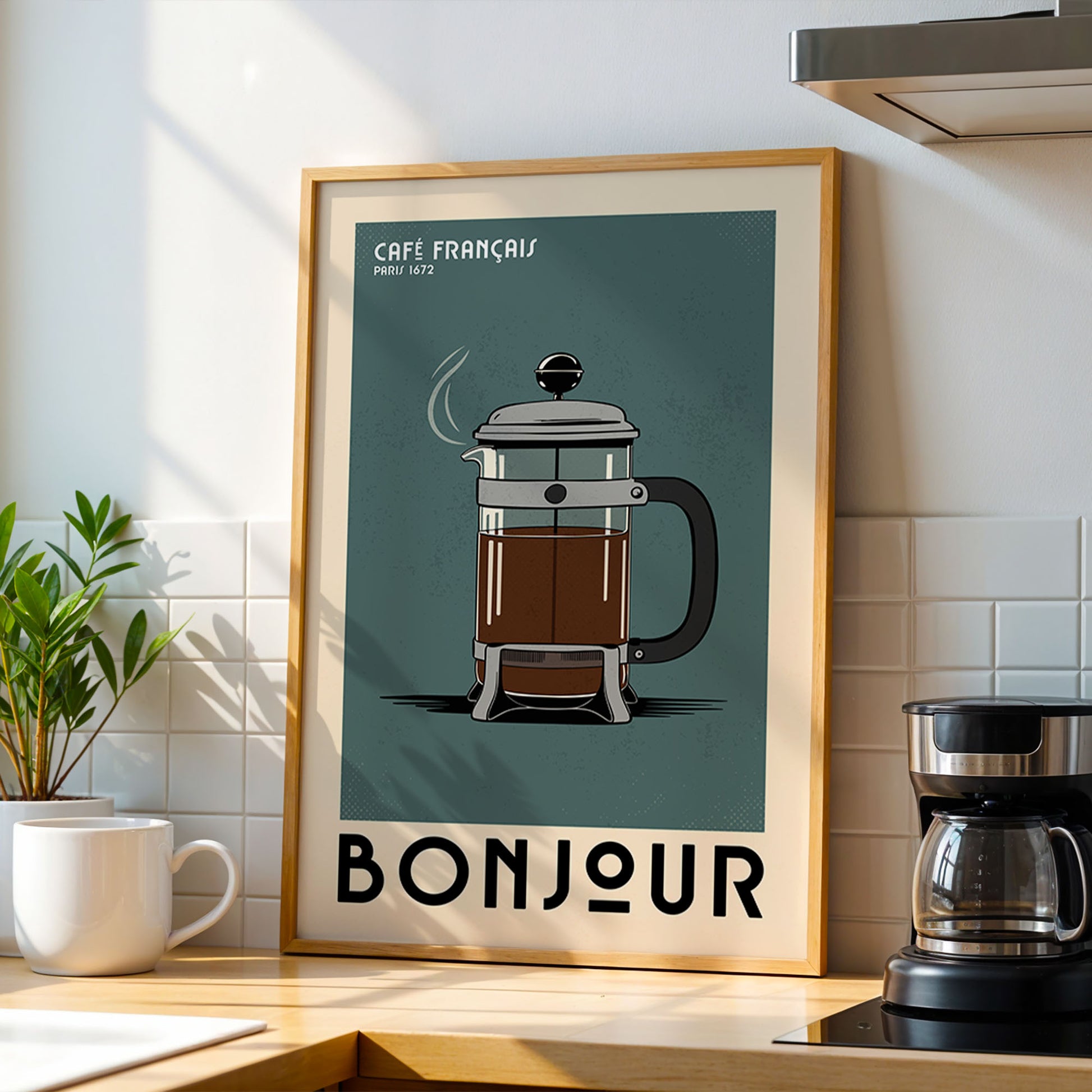 a framed poster of a French press coffee maker, with the word "BONJOUR" written below it.
