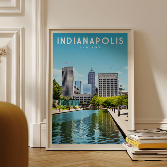 A framed poster of the Indianapolis skyline, featuring the city's iconic buildings and a reflecting pool, is displayed on a wall.