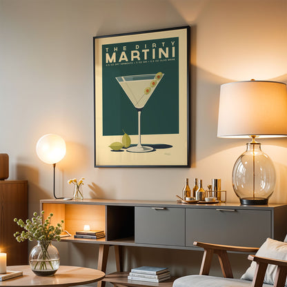 a living room with a framed poster of a martini glass hanging on the wall, a wooden sideboard with various items on it, and a lamp on a table.