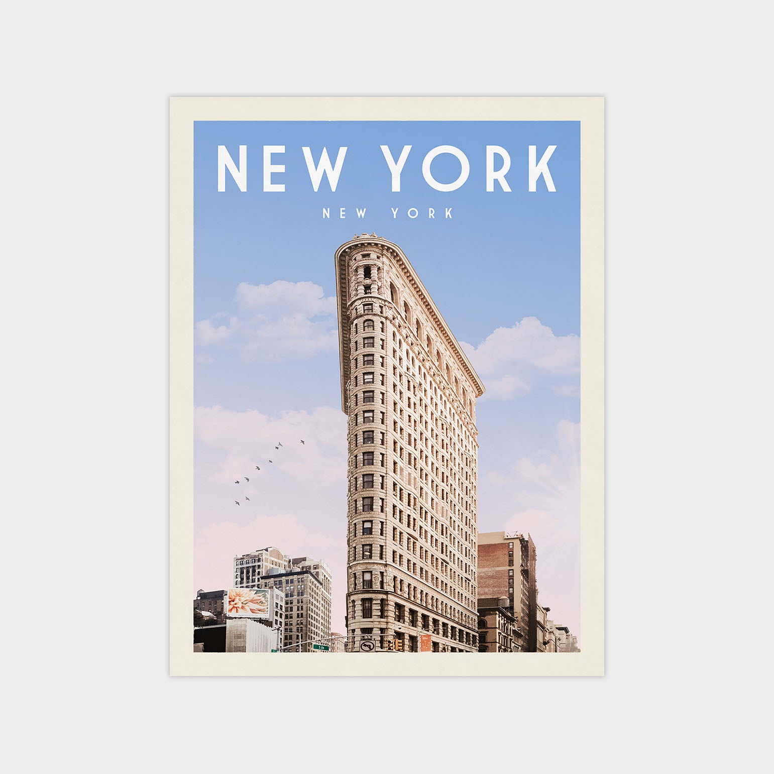 A tall, ornate building with a distinctive rounded corner, set against a clear blue sky with a few birds flying in the distance.