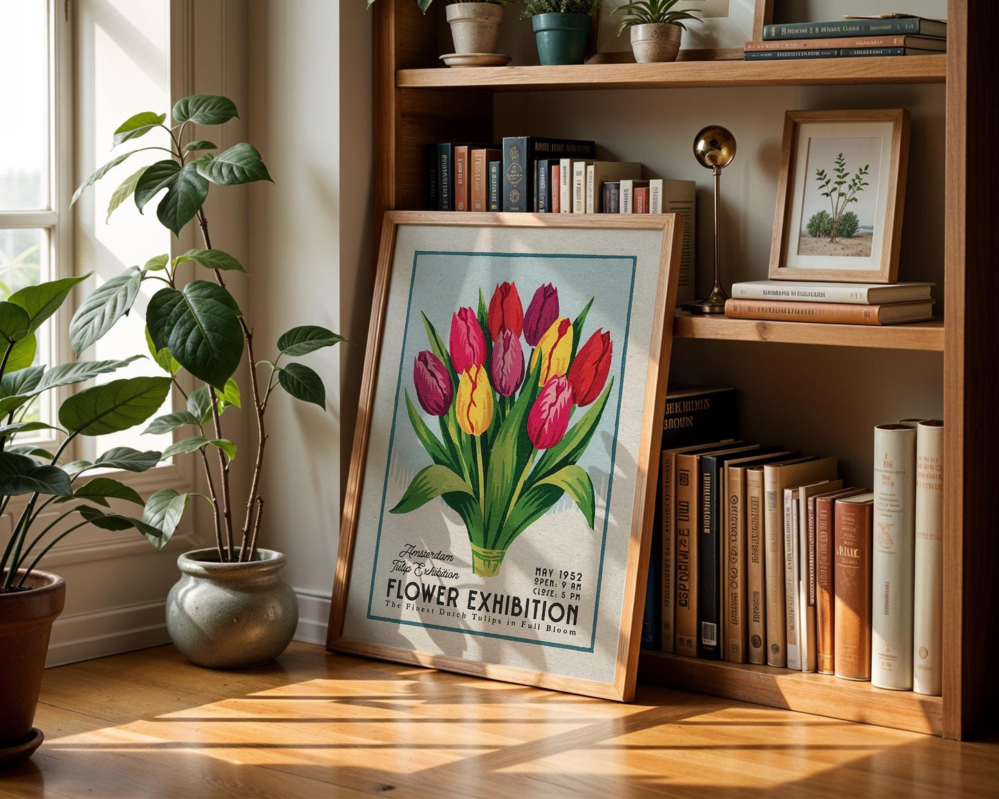 a picture of flowers on a shelf next to a potted plant