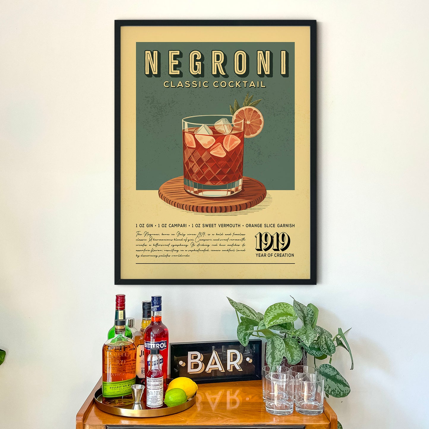 a framed poster of a Negroni cocktail on a wall above a wooden bar counter with various liquor bottles and glasses.
