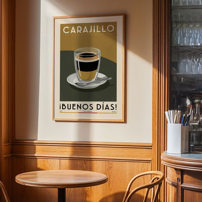 a framed poster of a cup of coffee with the text "CARAJILLO" and "IBUENOS DÍAS!" on it, hanging on a wall in a cafe setting.