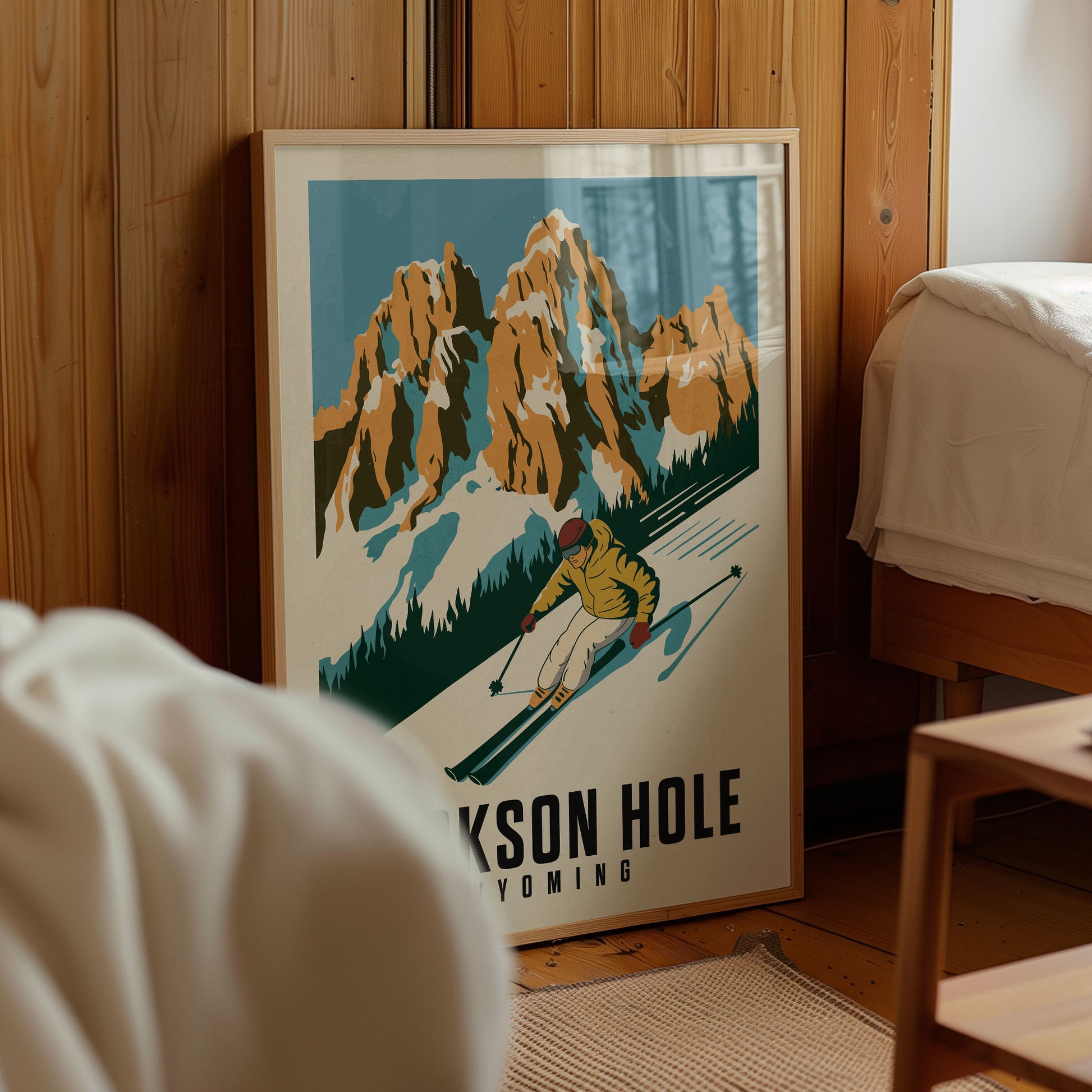 A framed poster of a skier on a mountain slope, with the text "JACKSON HOLE YELLOWING" below the illustration.