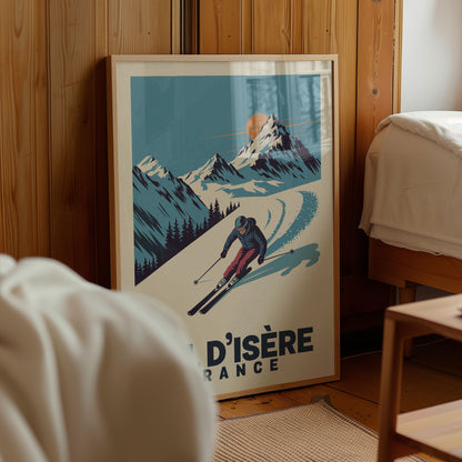 A framed poster of a skier in a snowy mountain landscape, with the text "D'ISÉRE FRANCE" below the illustration.