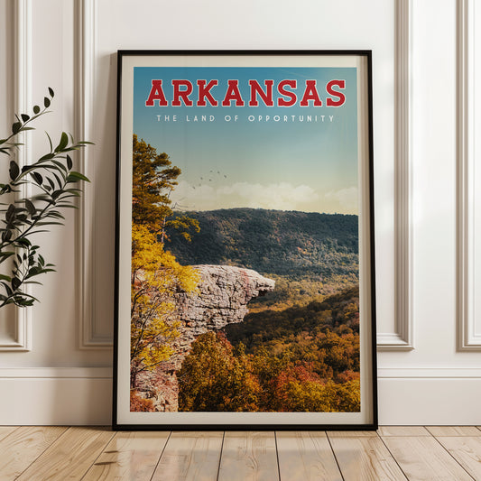 A framed poster of a scenic landscape in Arkansas, featuring a mountain with a cliff and trees in autumn colors.