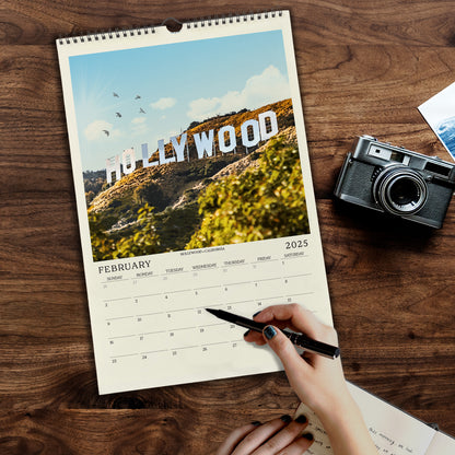 a person holding a pen and writing on a calendar