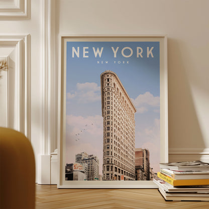 A framed poster of the Flatiron Building, a famous New York skyscraper, is displayed on a wall.