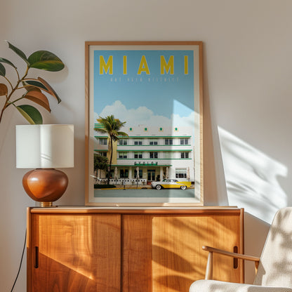 a framed poster of a tropical beach scene with palm trees and a yellow and white car, hanging on a wall above a wooden cabinet.