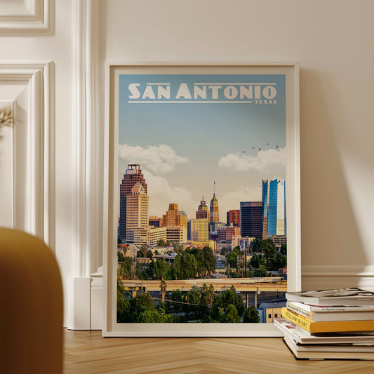 A framed poster of the San Antonio skyline in Texas, featuring a colorful and vibrant cityscape with tall buildings and a clear blue sky.