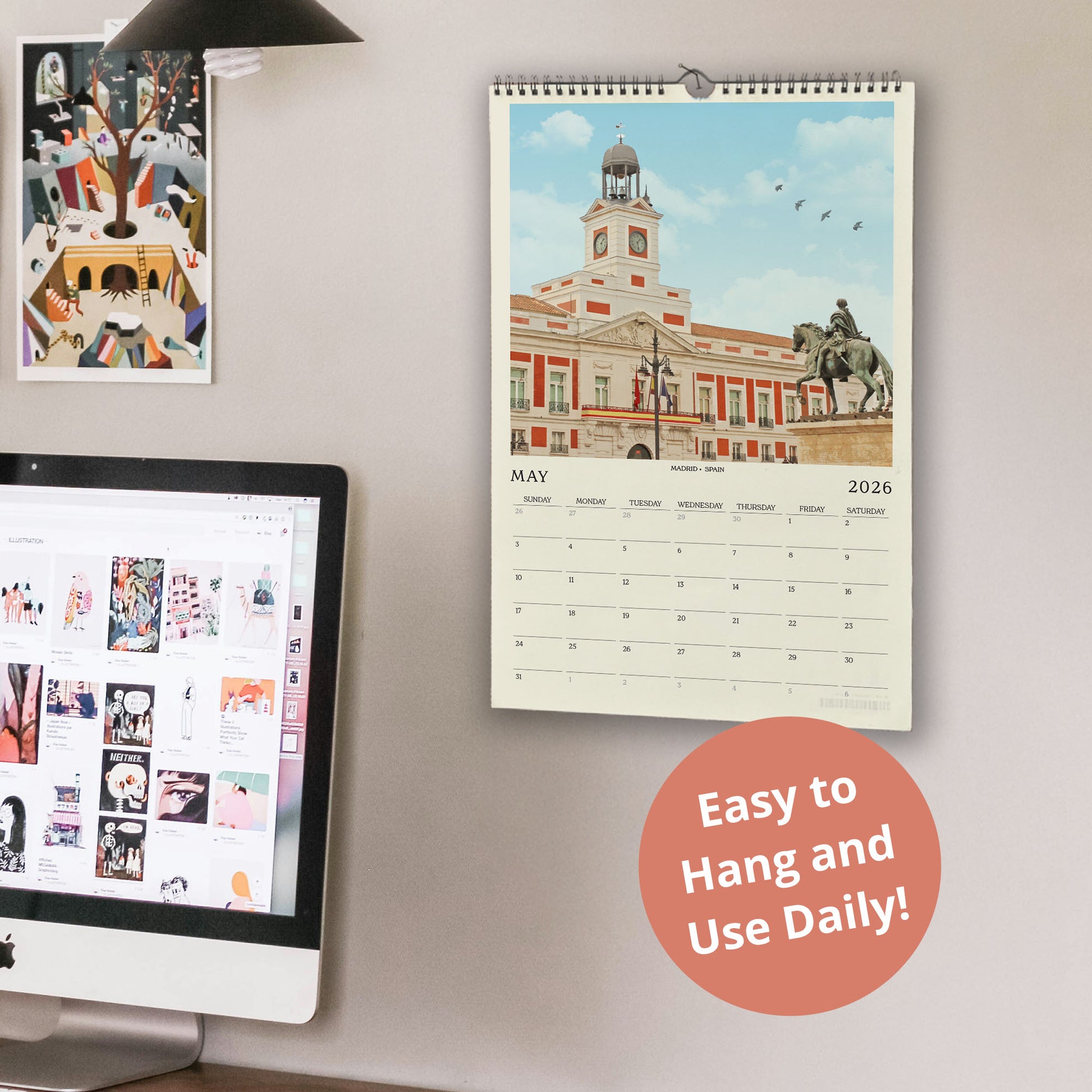 a wall with a calendar and a computer monitor, along with a few other items. The calendar displays a cityscape with a building and a statue, and the computer monitor shows a webpage with various images. There is also a text overlay that reads "Easy to Hang and Use Daily!"