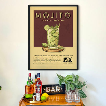 a framed poster of a classic Mojito cocktail hanging on a wall above a wooden bar counter with various liquor bottles and glasses.