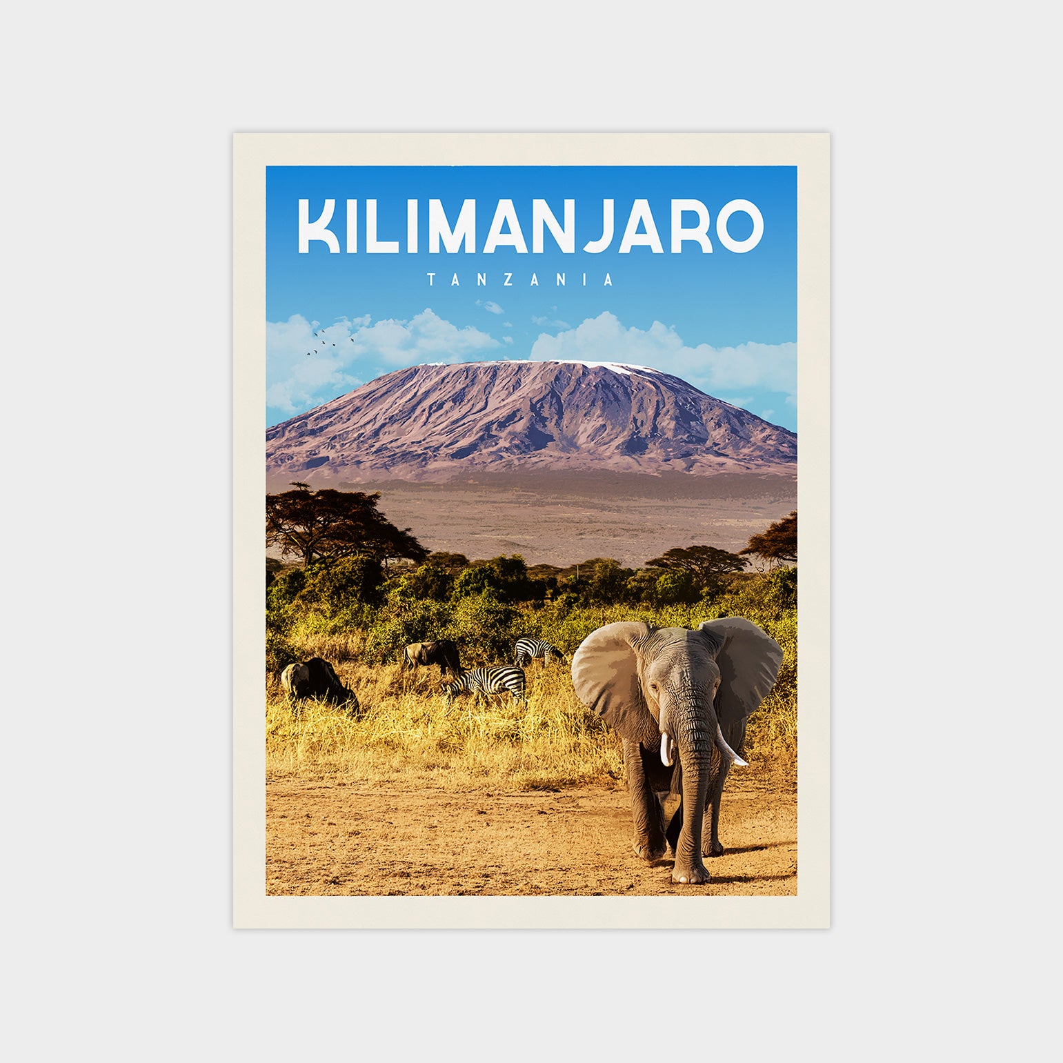 A poster of Kilimanjaro, the highest peak in Africa, with an elephant and zebras in the foreground and a large mountain in the background.