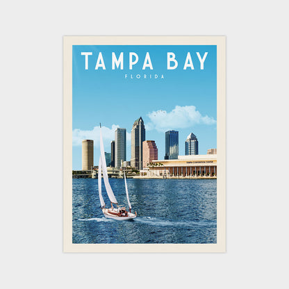 A sailboat on the water with the city skyline of Tampa Bay, Florida in the background.