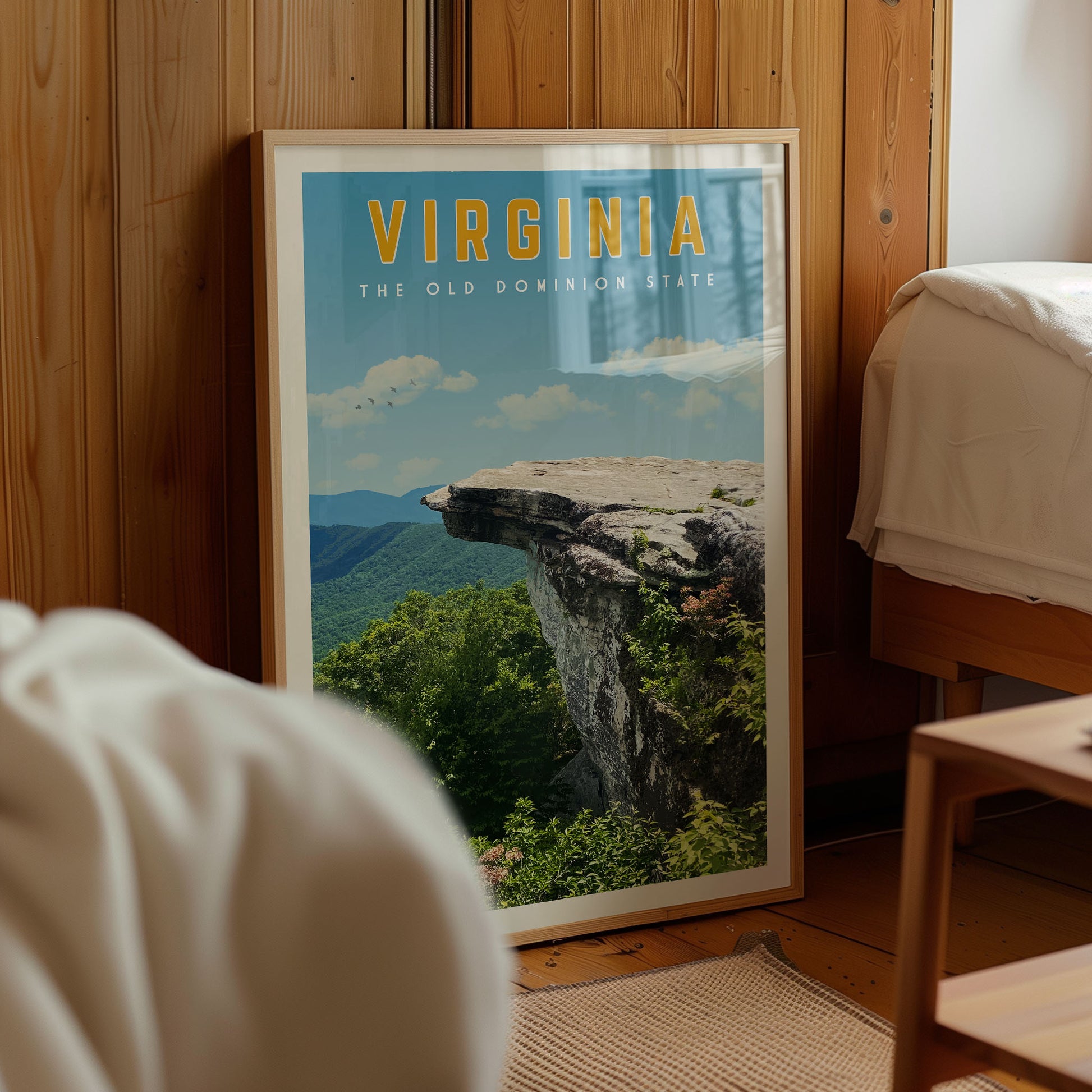 a framed poster of a scenic mountain landscape with a cliff, displaying the text "VIRGINIA THE OLD DOMINO STATE".