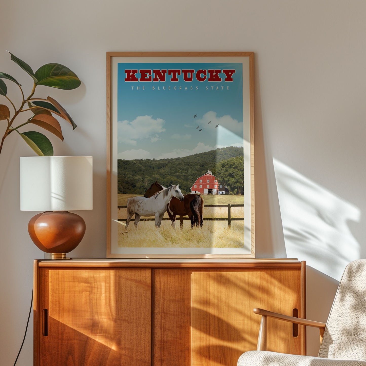 A framed poster of a horse and a barn in Kentucky, with the text "KENTUCKY THE BLUEgrass STATE" prominently displayed.