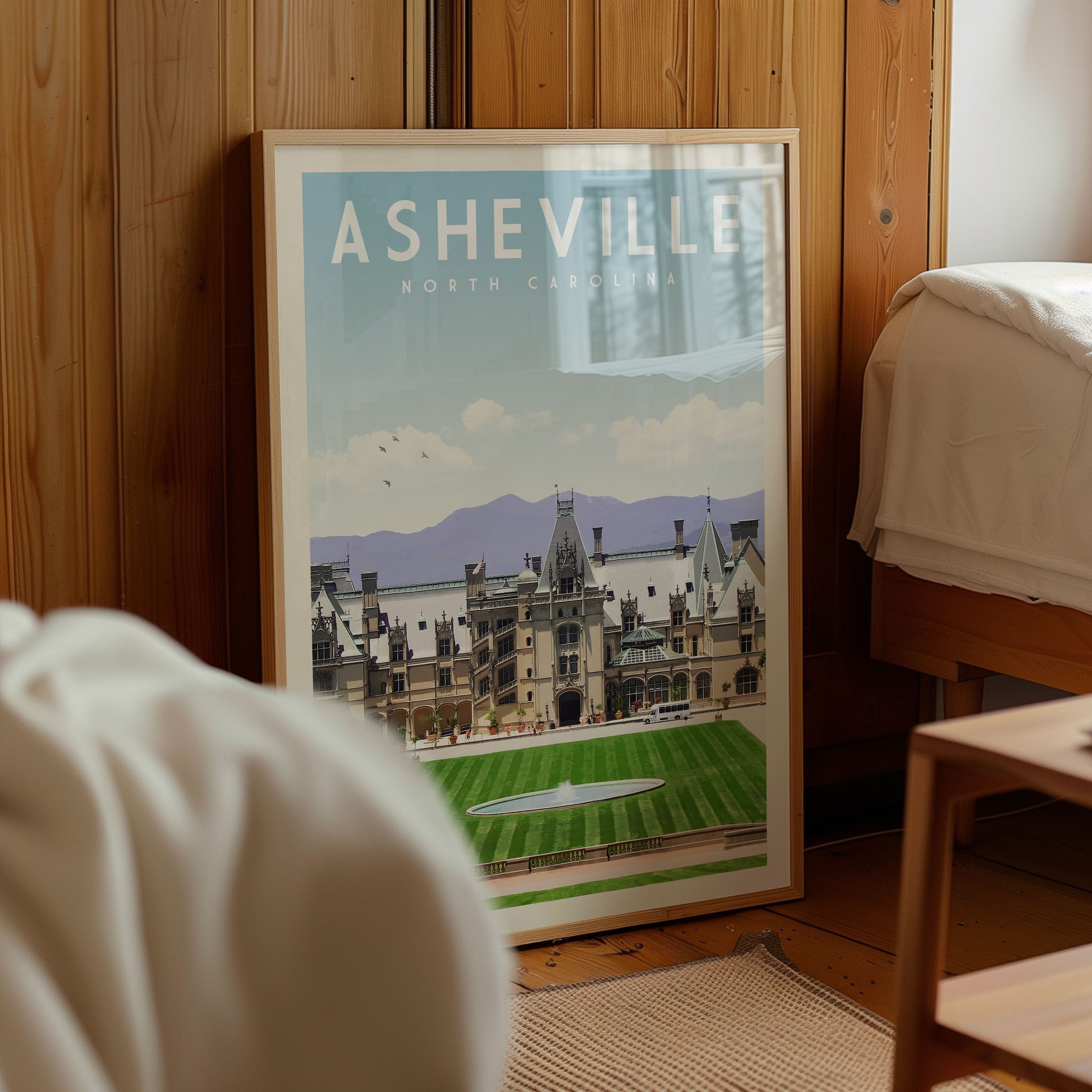A framed poster of the historic Asheville, North Carolina, with a detailed illustration of the city's architecture and landscape.