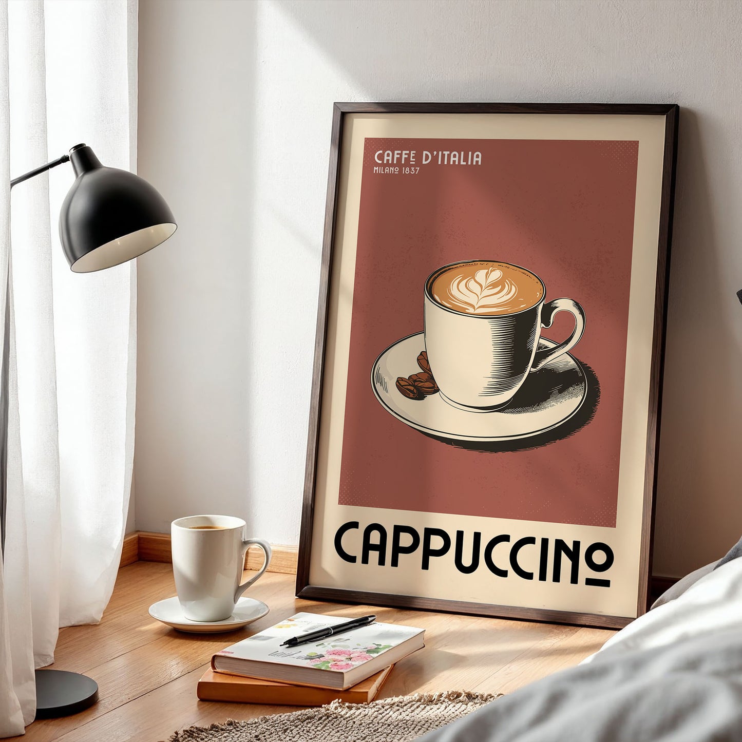 a framed poster of a cup of cappuccino, with a lamp and a book on a wooden floor in the foreground.
