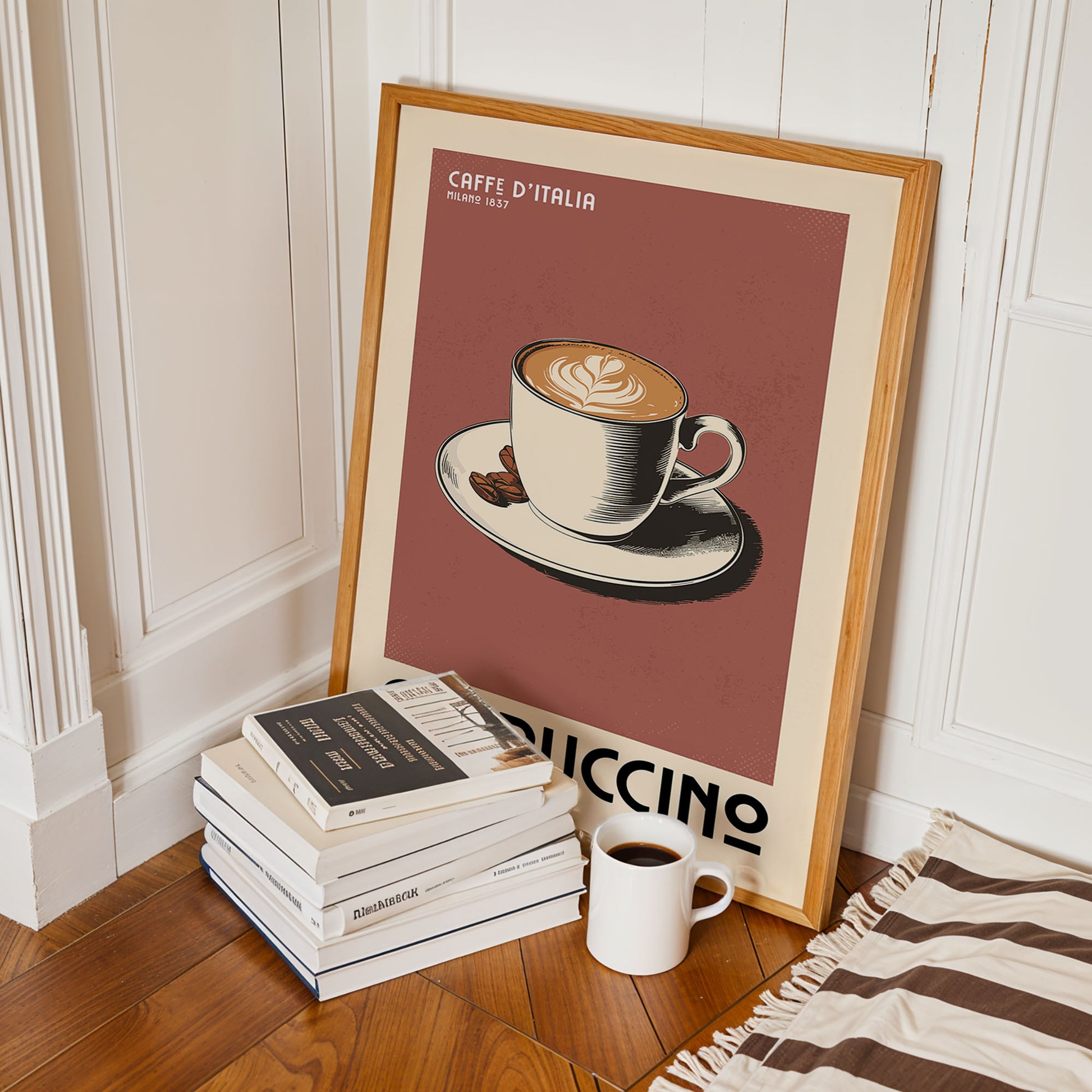 a framed poster of a cup of coffee with the text "CAFFE D'ITALIA" and "MILE 1657" on it, along with a stack of books and a mug of coffee on a wooden floor.