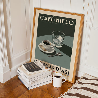 a framed poster of a coffee cup and saucer, along with a stack of books and a mug, all placed on a wooden floor.